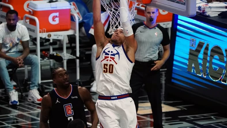 Apr 1, 2021; Los Angeles, California, USA; Denver Nuggets forward Aaron Gordon (50) dunks for a basket in front of Los Angeles Clippers forward Kawhi Leonard (2) during the first half at Staples Center. Mandatory Credit: Gary A. Vasquez-USA TODAY Sports