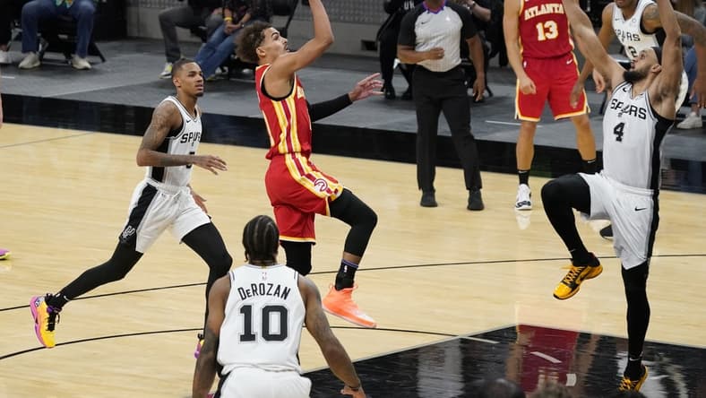Apr 1, 2021; San Antonio, Texas, USA; Atlanta Hawks guard Trae Young (11) attempts the final shot of the fourth quarter for the win over San Antonio Spurs guard Derrick White (4) at AT&T Center. Mandatory Credit: Scott Wachter-USA TODAY Sports