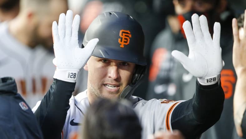 Apr 1, 2021; Seattle, Washington, USA; San Francisco Giants catcher Buster Posey (28) celebrates in the dugout after hitting a solo-home run against the Seattle Mariners during the second inning at T-Mobile Park. Mandatory Credit: Joe Nicholson-USA TODAY Sports