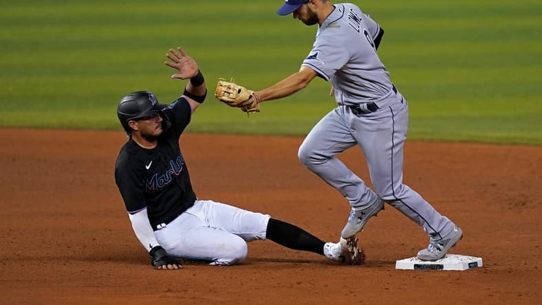 Apr 2, 2021; Miami, Florida, USA; Tampa Bay Rays second baseman Brandon Lowe (8) doubles off Miami Marlins shortstop Miguel Rojas (19) in the 4th inning at loanDepot park. Mandatory Credit: Jasen Vinlove-USA TODAY Sports