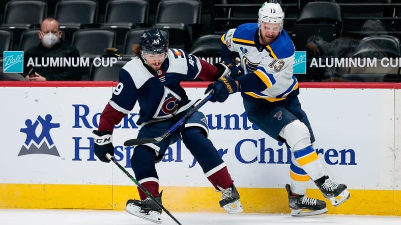 Apr 2, 2021; Denver, Colorado, USA; Colorado Avalanche defenseman Samuel Girard (49) and St. Louis Blues left wing Kyle Clifford (13) battle for the puck in the first period at Ball Arena. Mandatory Credit: Isaiah J. Downing-USA TODAY Sports