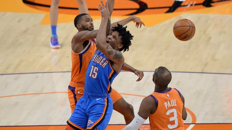Apr 2, 2021; Phoenix, Arizona, USA; Phoenix Suns forward Mikal Bridges (25) blocks a shot by Oklahoma City Thunder forward Josh Hall (15) during the first half at Phoenix Suns Arena. Mandatory Credit: Joe Camporeale-USA TODAY Sports