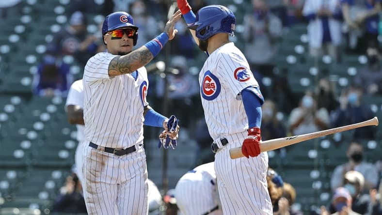 Apr 3, 2021; Chicago, Illinois, USA; Chicago Cubs shortstop Javier Baez (9) celebrates with second baseman David Bote (13) after scoring against the Pittsburgh Pirates in the second inning at Wrigley Field. Mandatory Credit: Kamil Krzaczynski-USA TODAY Sports