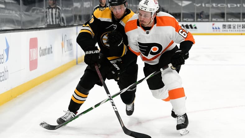Apr 5, 2021; Boston, Massachusetts, USA; Boston Bruins center Charlie Coyle (13) and Philadelphia Flyers defenseman Justin Braun (61) compete for position during the first period at the TD Garden. Mandatory Credit: Brian Fluharty-USA TODAY Sports
