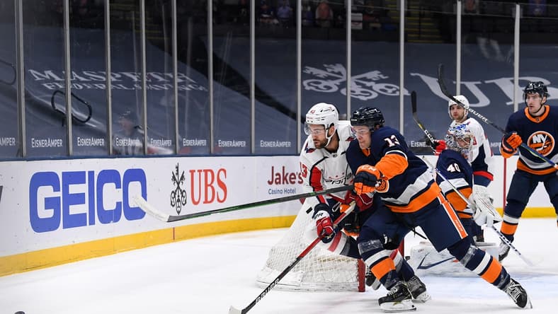 Apr 6, 2021; Uniondale, New York, USA; New York Islanders center Mathew Barzal (13) and Washington Capitals right wing Tom Wilson (43) battle for the puck during the first period between the New York Islanders and the Washington Capitals at Nassau Veterans Memorial Coliseum. Mandatory Credit: Dennis Schneidler-USA TODAY Sports