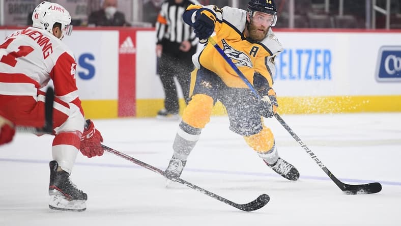 Apr 6, 2021; Detroit, Michigan, USA; Nashville Predators defenseman Mattias Ekholm (14) passes as Detroit Red Wings center Luke Glendening (41) defends during the first period at Little Caesars Arena. Mandatory Credit: Tim Fuller-USA TODAY Sports