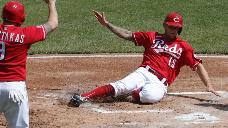 Apr 7, 2021; Cincinnati, Ohio, USA; Cincinnati Reds center fielder Nick Senzel (15) scores against the Pittsburgh Pirates during the first inning at Great American Ball Park. Mandatory Credit: David Kohl-USA TODAY Sports