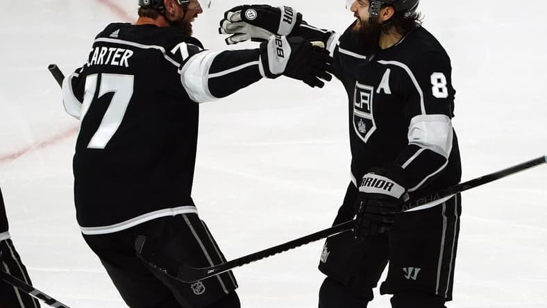 Apr 7, 2021; Los Angeles, California, USA; Los Angeles Kings center Jeff Carter (77) celebrates with defenseman Drew Doughty (8) his goal scored against the Arizona Coyotes during the third period at Staples Center. Mandatory Credit: Gary A. Vasquez-USA TODAY Sports