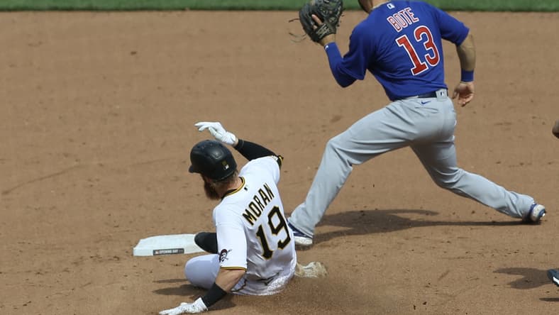 Apr 8, 2021; Pittsburgh, Pennsylvania, USA; Pittsburgh Pirates third baseman Colin Moran (19) slides into second base with a double as Chicago Cubs second baseman David Bote (13) takes a throw during the fifth inning at PNC Park. Mandatory Credit: Charles LeClaire-USA TODAY Sports