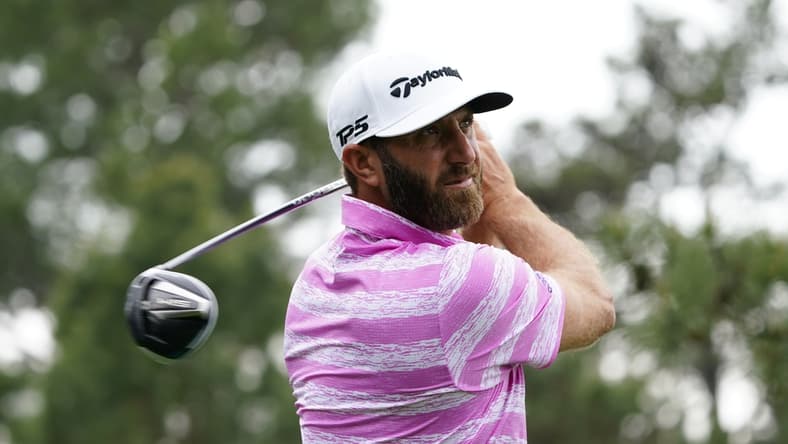 Apr 8, 2021; Augusta, Georgia, USA; Dustin Johnson hits his tee shot on the 18th hole during the first round of The Masters golf tournament. Mandatory Credit: Michael Madrid-USA TODAY Sports