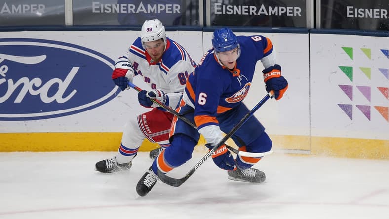 Apr 9, 2021; Uniondale, New York, USA; New York Rangers right wing Pavel Buchnevich (89) and New York Islanders defenseman Ryan Pulock (6) fight for the puck during the third period at Nassau Veterans Memorial Coliseum. Mandatory Credit: Brad Penner-USA TODAY Sports