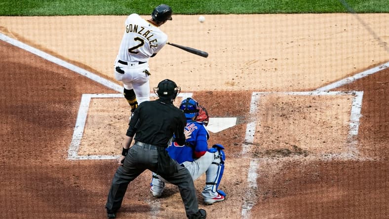 Apr 10, 2021; Pittsburgh, Pennsylvania, USA; Pittsburgh Pirates second baseman Erik Gonzalez (2) hits an RBI double against the Chicago Cubs at PNC Park. Mandatory Credit: Mark Alberti-USA TODAY Sports