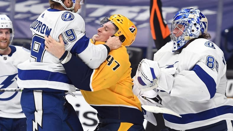 Apr 10, 2021; Nashville, Tennessee, USA; Tampa Bay Lightning right wing Barclay Goodrow (19) confronts Nashville Predators right wing Michael McCarron (47)  in the third period at Bridgestone Arena. Mandatory Credit: Christopher Hanewinckel-USA TODAY Sports