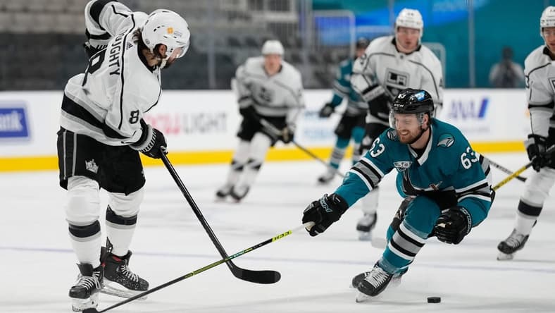 Apr 10, 2021; San Jose, California, USA; San Jose Sharks left wing Jeffrey Truchon-Viel (63) defends against Los Angeles Kings defenseman Drew Doughty (8) during the first periodat SAP Center at San Jose. Mandatory Credit: Stan Szeto-USA TODAY Sports