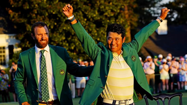 Apr 11, 2021; Augusta, Georgia, USA; Hideki Matsuyama celebrates with the green jacket presented by Dustin Johnson after winning The Masters golf tournament. Mandatory Credit: Michael Madrid-USA TODAY Sports