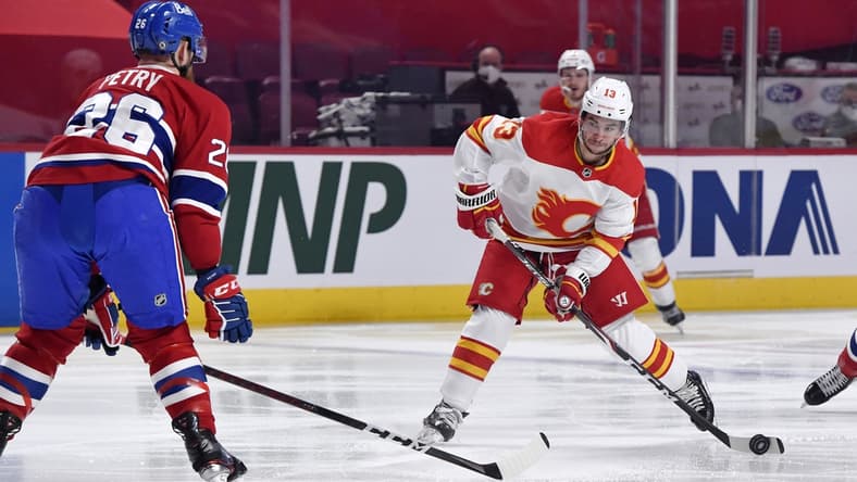 Apr 14, 2021; Montreal, Quebec, CAN; Calgary Flames forward Johnny Gaudreau (13) shoots the puck and Montreal Canadiens defenseman Jeff Petry (26) attempts to block during the first period at the Bell Centre. Mandatory Credit: Eric Bolte-USA TODAY Sports