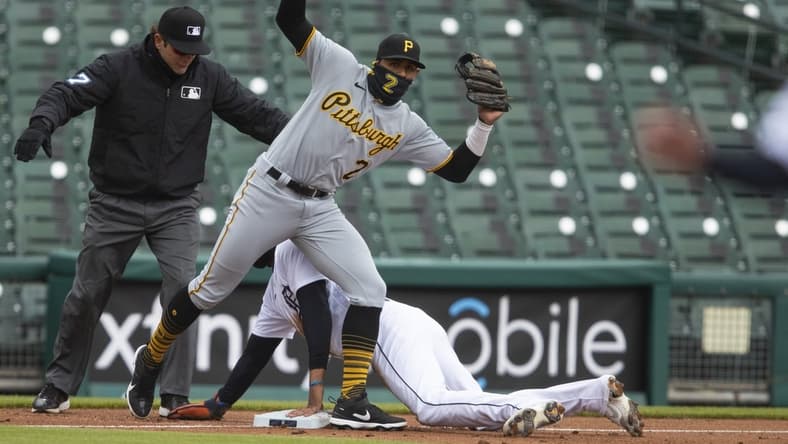Apr 21, 2021; Detroit, Michigan, USA; Detroit Tigers right fielder Victor Reyes (22) slides safely into third base against Pittsburgh Pirates second baseman Erik Gonzalez (2) during the third inning at Comerica Park. Mandatory Credit: Raj Mehta-USA TODAY Sports