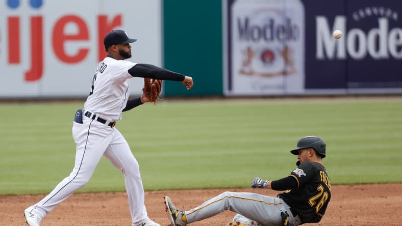 Apr 22, 2021; Detroit, Michigan, USA; Detroit Tigers shortstop Willi Castro (9) makes a throw to first for a double play as Pittsburgh Pirates second baseman Adam Frazier (26) slides into second in the fourth inning at Comerica Park. Mandatory Credit: Rick Osentoski-USA TODAY Sports
