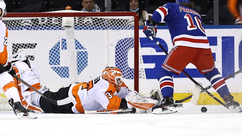 Apr 22, 2021; New York, New York, USA; Artemi Panarin #10 of the New York Rangers heads for the net as Brian Elliott #37 of the Philadelphia Flyers defends in the first period at Madison Square Garden. Mandatory Credit: Elsa/POOL PHOTOS-USA TODAY Sports
