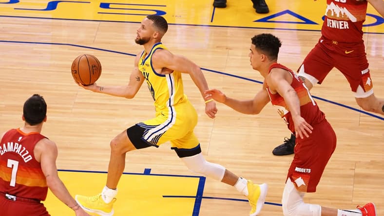 Apr 23, 2021; San Francisco, California, USA; Golden State Warriors guard Stephen Curry (30) drives in ahead of Denver Nuggets forward Michael Porter Jr. (1) during the second quarter at Chase Center. Mandatory Credit: Kelley L Cox-USA TODAY Sports