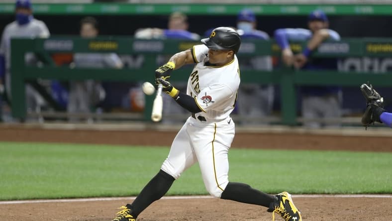 Apr 27, 2021; Pittsburgh, Pennsylvania, USA; Pittsburgh Pirates pinch hitter Wilmer Difo (15) hits an RBI single against the Kansas City Royals during the seventh inning at PNC Park. Mandatory Credit: Charles LeClaire-USA TODAY Sports