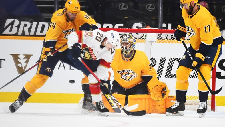 Apr 27, 2021; Nashville, Tennessee, USA; Nashville Predators goaltender Juuse Saros (74) makes a save with traffic from Florida Panthers center Aleksi Heponiemi (20) Florida Panthers defenseman Kevin Connauton (44) and Nashville Predators defenseman Ben Harpur (17) during the first period at Bridgestone Arena. Mandatory Credit: Christopher Hanewinckel-USA TODAY Sports