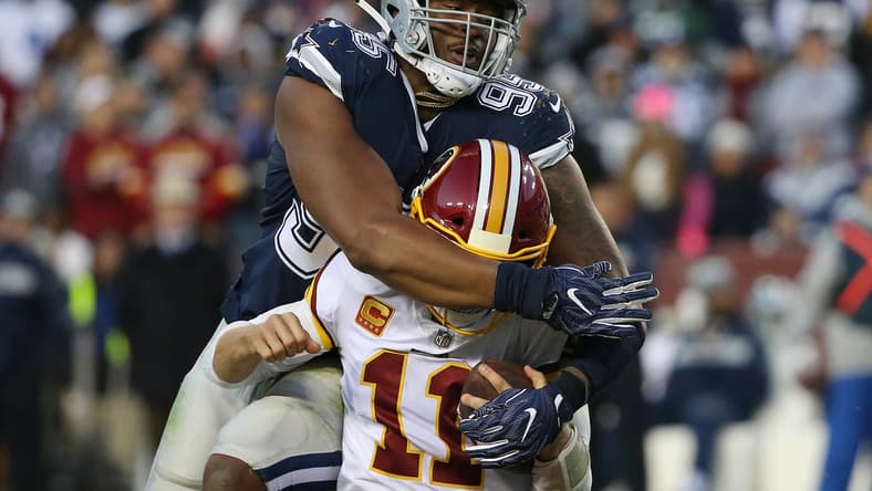 Oct 21, 2018; Landover, MD, USA; Washington Redskins quarterback Alex Smith (11) is tackled by Dallas Cowboys defensive tackle David Irving (95) in the fourth quarter at FedEx Field. Mandatory Credit: Geoff Burke-USA TODAY Sports