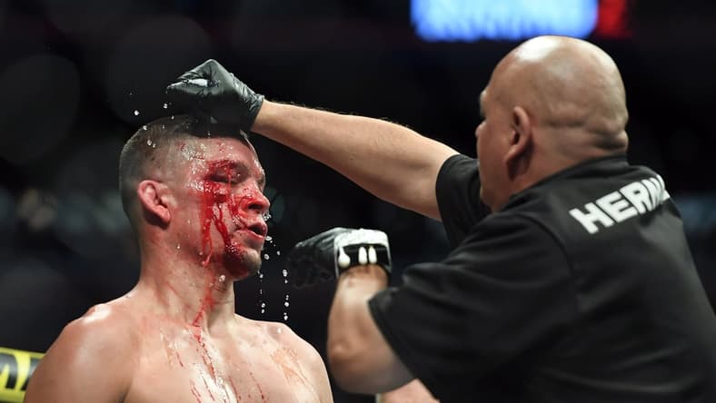 Nov 2, 2019; New York, NY, USA; Nate Diaz (blue gloves) gets treatment during his fight against Jorge Masvidal (red gloves) during UFC 244 at Madison Square Garden. Mandatory Credit: Sarah Stier-USA TODAY Sports