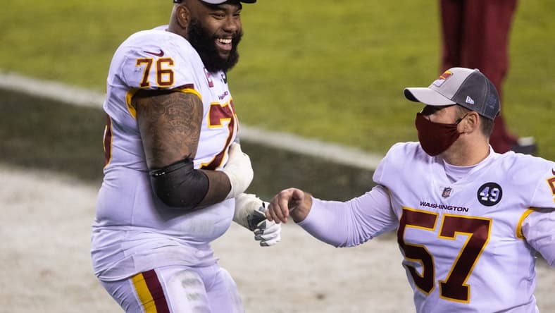 Jan 3, 2021; Philadelphia, Pennsylvania, USA; Washington Football Team offensive tackle Morgan Moses (76) and long snapper Nick Sundberg (57) celebrate after winning the NFC East championship in a game against the Philadelphia Eagles at Lincoln Financial Field. Mandatory Credit: Bill Streicher-USA TODAY Sports