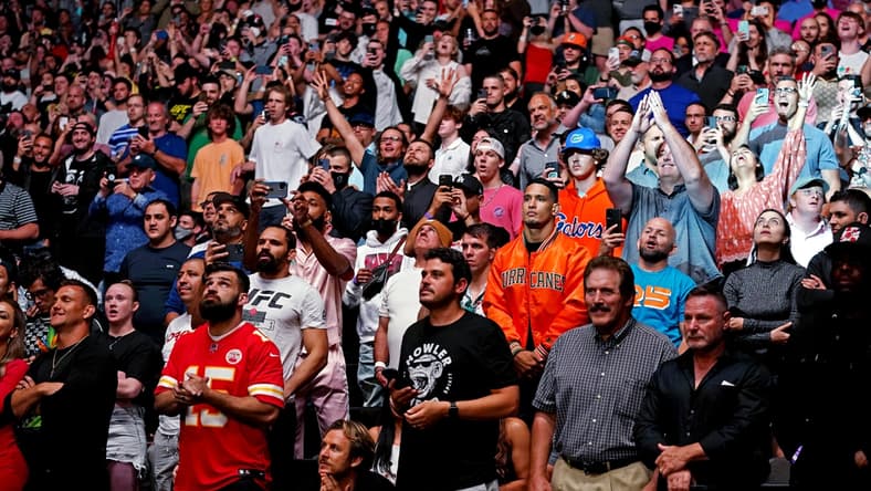 Apr 24, 2021; Jacksonville, Florida, USA; Fans cheer at the start of the fight between Kamaru Usman (Red Gloves) and Jorge Masvidal (Blue Gloves) during UFC 261 at VyStar Veterans Memorial Arena. Mandatory Credit: Jasen Vinlove-USA TODAY Sports