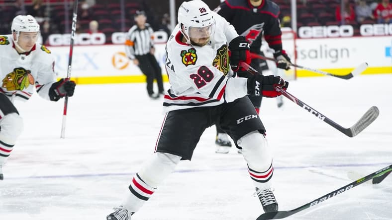 May 3, 2021; Raleigh, North Carolina, USA; Chicago Blackhawks left wing Vinnie Hinostroza (28) takes a shot during the second period against the Carolina Hurricanes at PNC Arena. Mandatory Credit: James Guillory-USA TODAY Sports
