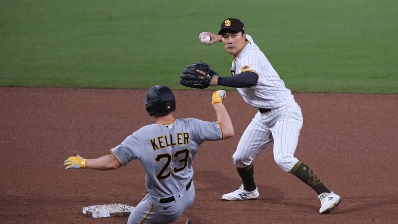 May 4, 2021; San Diego, California, USA; San Diego Padres shortstop Ha-seong Kim (R) throws to first base after forcing out Pittsburgh Pirates starting pitcher Mitch Keller (23) at second base during the fifth inning at Petco Park. Mandatory Credit: Orlando Ramirez-USA TODAY Sports
