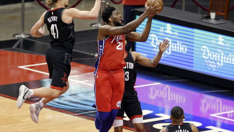 May 5, 2021; Houston, Texas, USA; Philadelphia 76ers center Joel Embiid (21) gets a shot up past Houston Rockets forward Kelly Olynyk (41) and guard Kevin Porter Jr., right, during the second half at Toyota Center. Mandatory Credit: Michael Wyke/POOL PHOTOS-USA TODAY Sports