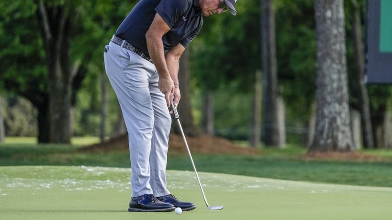 May 6, 2021; Charlotte, North Carolina, USA;  Phil Mickelson putts for his two stroke lead at 9 during the first round of the Wells Fargo Championship golf tournament. Mandatory Credit: Jim Dedmon-USA TODAY Sports