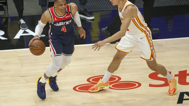 May 10, 2021; Atlanta, Georgia, USA; Washington Wizards guard Russell Westbrook (4) is defended by Atlanta Hawks guard Bogdan Bogdanovic (13) in the first quarter at State Farm Arena. Mandatory Credit: Brett Davis-USA TODAY Sports
