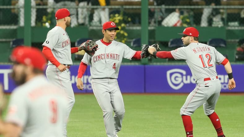 May 10, 2021; Pittsburgh, Pennsylvania, USA; Cincinnati Reds center fielder Nick Senzel (left) and left fielder Shogo Akiyama (4) and right fielder Tyler Naquin (12) celebrate after defeating the Pittsburgh Pirates at PNC Park. The Reds won 14-1. Mandatory Credit: Charles LeClaire-USA TODAY Sports