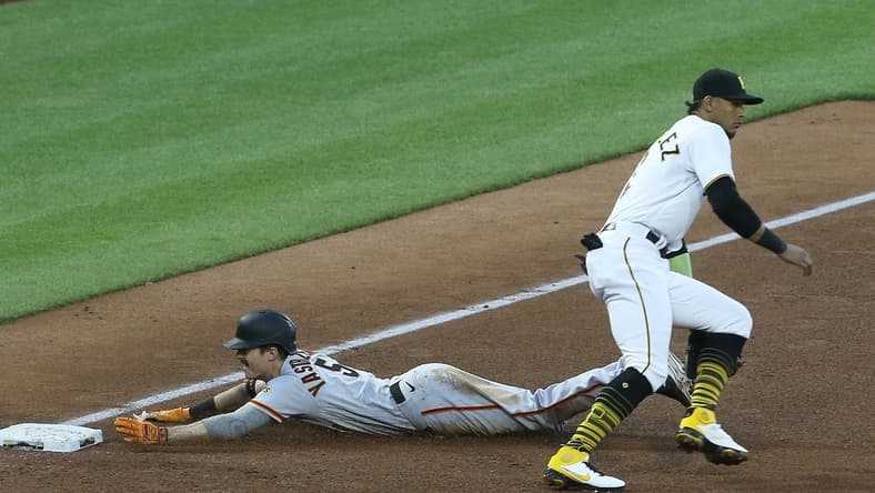 May 13, 2021; Pittsburgh, Pennsylvania, USA; San Francisco Giants right fielder Mike Yastrzemski (5) slides into third base with an RBI triple as Pittsburgh Pirates third baseman Erik Gonzalez (2) awaits the throw during the fifth inning at PNC Park. Mandatory Credit: Charles LeClaire-USA TODAY Sports