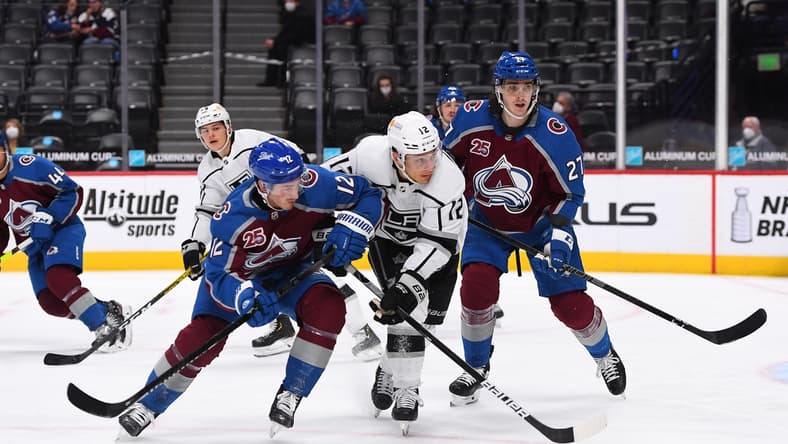 May 13, 2021; Denver, Colorado, USA; Colorado Avalanche center Jayson Megna (12) and Los Angeles Kings center Trevor Moore (12) and defenseman Ryan Graves (27) during the first period at Ball Arena. Mandatory Credit: Ron Chenoy-USA TODAY Sports