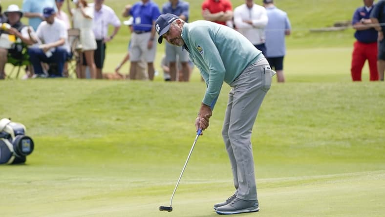 May 14, 2021; McKinney, Texas, USA; Matt Kuchar putts on the 18th green during the second round of the AT&T Byron Nelson golf tournament. Mandatory Credit: Jim Cowsert-USA TODAY Sports