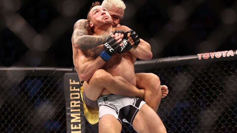 May 15, 2021; Houston, Texas, USA; Charles Oliveira brings down Michael Chandler during UFC 262 at Toyota Center. Mandatory Credit: Troy Taormina-USA TODAY Sports