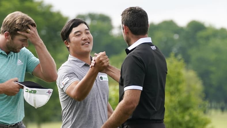 May 16, 2021; McKinney, Texas, USA; K.H. Lee is congratulated by Charl Schwartzel for his tournament win during the final round of the AT&T Byron Nelson golf tournament. Mandatory Credit: Jim Cowsert-USA TODAY Sports