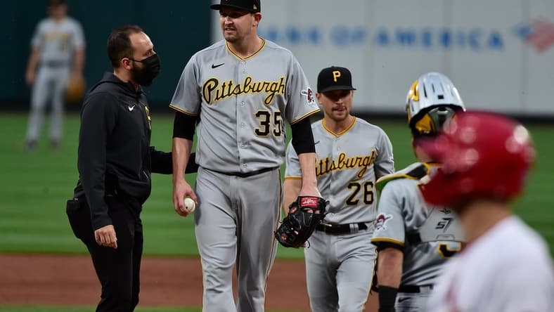 May 19, 2021; St. Louis, Missouri, USA;  Pittsburgh Pirates starting pitcher Trevor Cahill (35) talks with a trainer prior to being removed from the game during the second inning against the St. Louis Cardinals at Busch Stadium. Mandatory Credit: Jeff Curry-USA TODAY Sports
