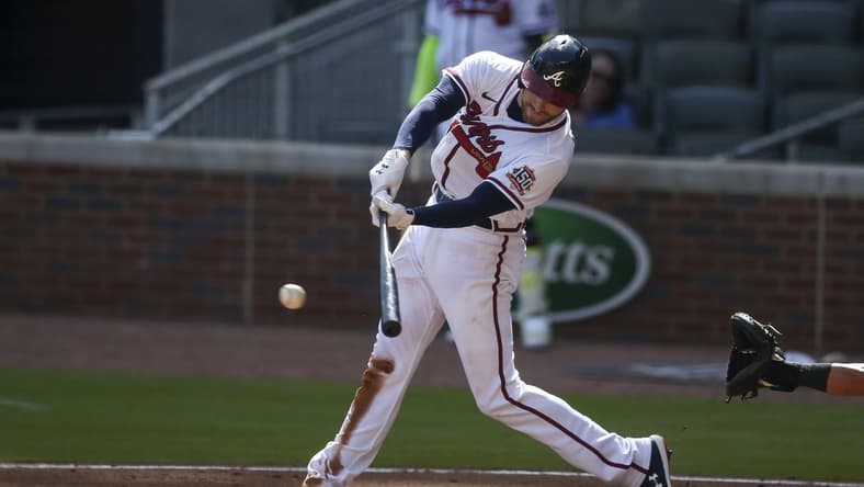 May 22, 2021; Atlanta, Georgia, USA; Atlanta Braves first baseman Freddie Freeman (5) hits a RBI single against the Pittsburgh Pirates in the second inning at Truist Park. Mandatory Credit: Brett Davis-USA TODAY Sports