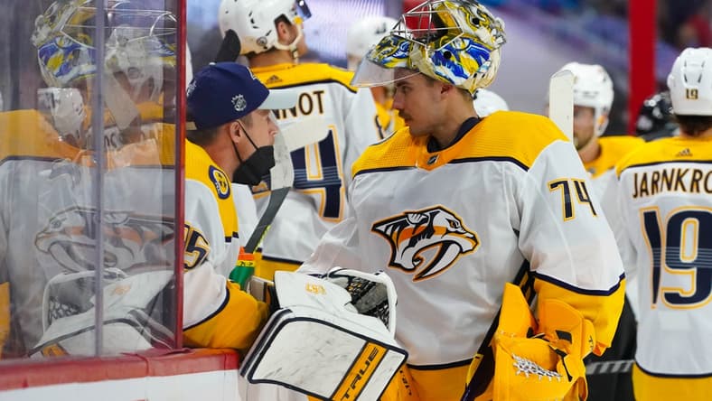 May 17, 2021; Raleigh, North Carolina, USA; Nashville Predators goaltender Juuse Saros (74) and goaltender Pekka Rinne (35) talk at the bench against the Carolina Hurricanes in game one of the first round of the 2021 Stanley Cup Playoffs at PNC Arena. Mandatory Credit: James Guillory-USA TODAY Sports