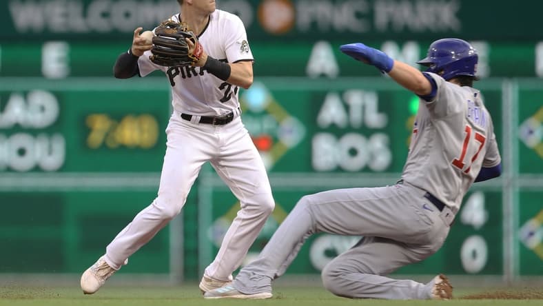 May 26, 2021; Pittsburgh, Pennsylvania, USA;  Pittsburgh Pirates shortstop Kevin Newman (27) forces Chicago Cubs first baseman Kris Bryant (17) out at second base during the second inning at PNC Park. Mandatory Credit: Charles LeClaire-USA TODAY Sports