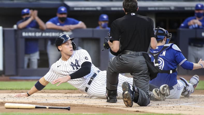 May 27, 2021; Bronx, New York, USA; New York Yankees designated hitter Aaron Judge (99) is tagged out at home by Toronto Blue Jays catcher Danny Jansen (9) in the first inning at Yankee Stadium. Mandatory Credit: Wendell Cruz-USA TODAY Sports