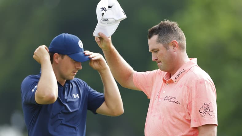 May 30, 2021; Fort Worth, Texas, USA; Charles Schwab Challenge winner Jason Kokrak tips his cap to the crowd after beating runner-up Jordan Spieth in the final round of the Charles Schwab Challenge golf tournament. Mandatory Credit: Erich Schlegel-USA TODAY Sports