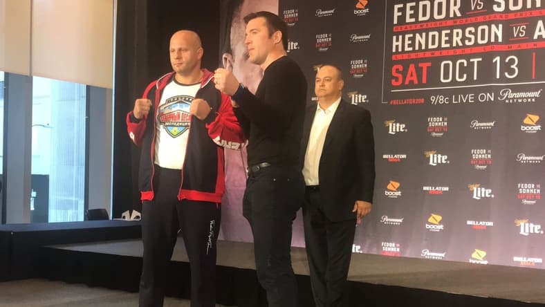Fedor Emelianenko and Chael Sonnen pose for photographs at a media event Thursday, Oct. 11, 2018, to promote their Bellator 208 main event Saturday, Oct. 13, 2018, at Long Island's Nassau Coliseum. Bellator President Scott Coker looks on in the background.

Fedor Emelianenko vs Chael Sonnen