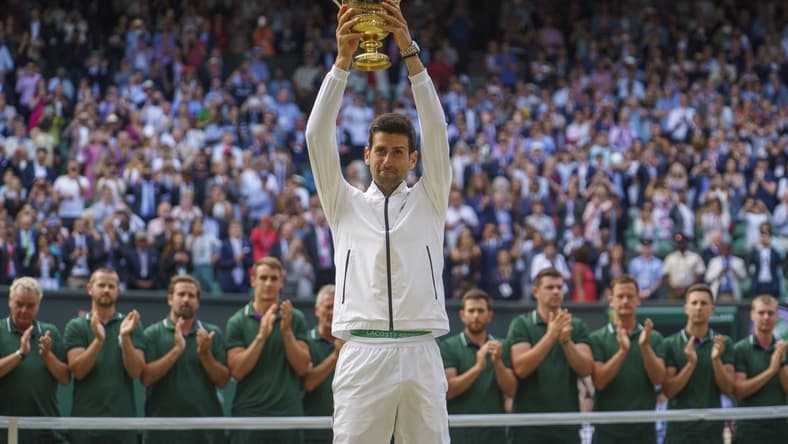 Jul 14, 2019; London, United Kingdom; Novak Djokovic (SRB) lifts the trophy after his mens final match against Roger Federer (SUI) on day 13 at the All England Lawn and Croquet Club. Mandatory Credit: Susan Mullane-USA TODAY Sports