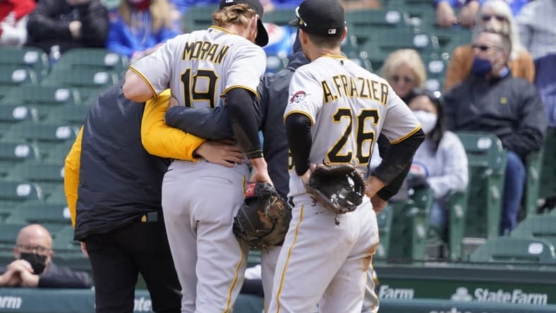 May 8, 2021; Chicago, Illinois, USA; Pittsburgh Pirates first baseman Colin Moran (19) leaves the game after being hurt on a play at first base against the Chicago Cubs during the first inning at Wrigley Field. Mandatory Credit: David Banks-USA TODAY Sports